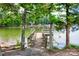 Private wooden dock offering a serene spot to enjoy the lake and water views framed by mature trees at 270 Yachtsman Dr, Salisbury, NC 28146