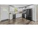 Modern kitchen featuring sleek black appliances, white cabinets, and wood flooring at 270 Yachtsman Dr, Salisbury, NC 28146