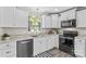 Well-lit kitchen featuring white cabinets, stainless steel appliances, and stylish countertops at 270 Yachtsman Dr, Salisbury, NC 28146