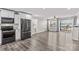 Open-concept kitchen and living room with wood floors and sliding glass doors to the deck at 270 Yachtsman Dr, Salisbury, NC 28146