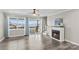 Sunlit living room with hardwood floors, fireplace, and glass doors leading to a deck with lake view at 270 Yachtsman Dr, Salisbury, NC 28146