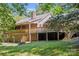 A two-story brick house features a large wooden deck overlooking a sloped, grassy backyard at 3090 Goblet Rd, Richburg, SC 29729