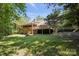 A two-story brick house features a large wooden deck overlooking a sloped, grassy backyard at 3090 Goblet Rd, Richburg, SC 29729
