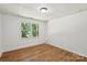 Bedroom featuring wood-look flooring and backyard views at 3090 Goblet Rd, Richburg, SC 29729