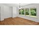 A dining room with laminate flooring, white walls and trim, and a window view of a lush green outdoor area at 3090 Goblet Rd, Richburg, SC 29729