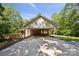The rear of a brick home with a large concrete patio, wooden deck, and an exterior door at 3090 Goblet Rd, Richburg, SC 29729