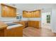 Open kitchen with wood cabinets, white countertops, stainless steel appliances, and laminate flooring at 3090 Goblet Rd, Richburg, SC 29729