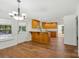 Bright kitchen featuring wood cabinets, laminate flooring, a breakfast bar, and exterior access at 3090 Goblet Rd, Richburg, SC 29729