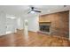 Open-concept living room featuring a brick fireplace and hardwood floors at 3090 Goblet Rd, Richburg, SC 29729