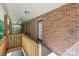 Covered brick patio with wooden railing and entrance into home at 3090 Goblet Rd, Richburg, SC 29729