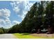 A picturesque street view captures Huntington Oaks under a sunny sky with vibrant green lawns and lush trees at 3090 Goblet Rd, Richburg, SC 29729