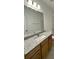 Bathroom featuring granite countertop, vanity, and mirror, with abundant lighting and a bright ambiance at 353 Jetton St, Davidson, NC 28036