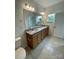 Bright bathroom featuring double vanity with granite countertop and large mirror, providing ample space and natural light at 353 Jetton St, Davidson, NC 28036