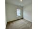 A tidy bedroom with neutral carpeting and natural light, providing a comfortable and serene atmosphere at 353 Jetton St, Davidson, NC 28036