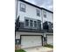 Townhome with a modern exterior and balcony, blending contemporary design with functional outdoor living space at 353 Jetton St, Davidson, NC 28036