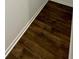 Close-up of dark wood-look vinyl flooring accented with white baseboards at 353 Jetton St, Davidson, NC 28036