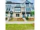Beautiful townhome featuring brick facade, multiple windows, and well-maintained landscaping at 353 Jetton St, Davidson, NC 28036