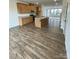 Stylish open kitchen with granite countertops, wood cabinets, and luxury vinyl plank flooring at 353 Jetton St, Davidson, NC 28036