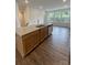 Bright kitchen featuring a granite-topped island and wood cabinets with stainless sink at 353 Jetton St, Davidson, NC 28036