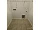 Functional laundry room with tile flooring, featuring essential hookups and ample space for cleaning tasks at 353 Jetton St, Davidson, NC 28036