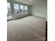 Open-concept living room area with door and windows allowing lots of natural light at 353 Jetton St, Davidson, NC 28036