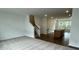 Large living area features carpet and views of kitchen and access to staircase at 353 Jetton St, Davidson, NC 28036