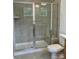Spacious shower with glass doors and tile surround, offering a modern and clean bathing experience at 353 Jetton St, Davidson, NC 28036