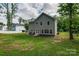 Exterior view of home and landscaped backyard with patio seating at 360 Sundown Rd, Mooresville, NC 28117