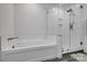 Bright bathroom showcasing a soaking tub and tiled shower with glass surround at 360 Sundown Rd, Mooresville, NC 28117