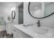 A modern bathroom features a circular mirror, white vanity, and silver fixtures at 360 Sundown Rd, Mooresville, NC 28117
