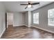 Bedroom with wood-look floors, a ceiling fan, and natural light from two windows at 360 Sundown Rd, Mooresville, NC 28117