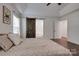 Bedroom with wood-look floors, barn door to bathroom, and open doorway at 360 Sundown Rd, Mooresville, NC 28117