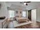 Bedroom with tray ceiling, ceiling fan, and wood-look floors at 360 Sundown Rd, Mooresville, NC 28117