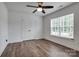 A well-lit bedroom features a ceiling fan, a window, and a double-door closet at 360 Sundown Rd, Mooresville, NC 28117