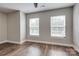 Bedroom featuring wood-look floors, neutral walls, and natural light from two windows at 360 Sundown Rd, Mooresville, NC 28117