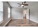 Bedroom showcasing wood-look floors, two windows, and access to the staircase at 360 Sundown Rd, Mooresville, NC 28117