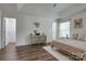 Bedroom with wood-look floors, windows, and access to additional rooms at 360 Sundown Rd, Mooresville, NC 28117