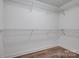 Spacious walk-in closet featuring wire shelving and wood-look floors at 360 Sundown Rd, Mooresville, NC 28117
