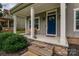 Inviting front porch featuring stone accents and a bright blue door at 360 Sundown Rd, Mooresville, NC 28117