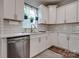 Bright kitchen with white cabinets, stainless steel appliances, and a window with hanging plants at 360 Sundown Rd, Mooresville, NC 28117