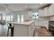 Open concept kitchen with white cabinets, stainless steel appliances, and a large island at 360 Sundown Rd, Mooresville, NC 28117