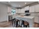 Bright kitchen with stainless appliances, island seating, and subway tile backsplash at 360 Sundown Rd, Mooresville, NC 28117