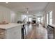 Open concept living room with fireplace, hardwood floors, and access to the kitchen at 360 Sundown Rd, Mooresville, NC 28117