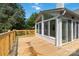Wooden deck with a view of the backyard and sun room, enhancing the outdoor space at 3801 Rea Rd, Charlotte, NC 28226
