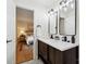 Double sink bathroom with modern finishes adjacent to a bedroom at 3801 Rea Rd, Charlotte, NC 28226