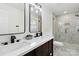 Bathroom featuring double sinks, matte black hardware, and a glass shower at 3801 Rea Rd, Charlotte, NC 28226