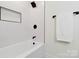 Modern bathroom features white subway tile, black fixtures, and a shower with a recessed shelf at 3801 Rea Rd, Charlotte, NC 28226