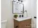 Well-lit bathroom with wood-grain vanity, and modern black fixtures at 3801 Rea Rd, Charlotte, NC 28226