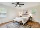 Cozy bedroom featuring two windows, ceiling fan, rug, and soft natural light at 3801 Rea Rd, Charlotte, NC 28226