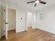 Bright bedroom boasts hardwood floors, a ceiling fan, and a walk-in closet at 3801 Rea Rd, Charlotte, NC 28226